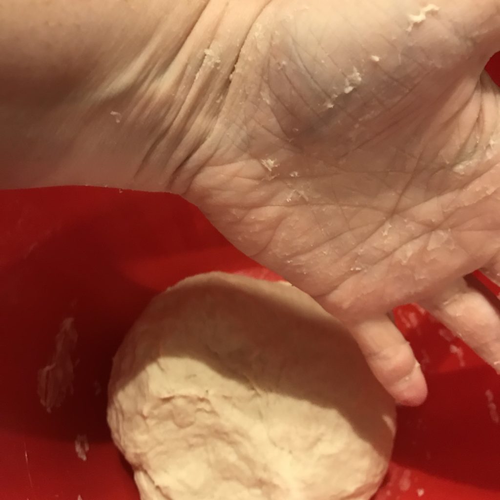 kneading dough in a bowl